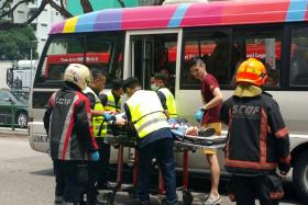 BADLY HURT: Paramedics attending to Ms Yong Soh Mui at the scene of the accident at Lorong 1 Toa Payoh. 
