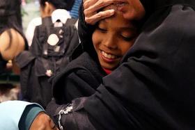 HAPPY: A tearful reunion between Madam Siti Fatimah Salim, her recently returned son Fairuz, and one of his sisters.