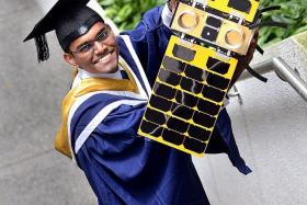 SUCCESS: Valedictorian A Saravanan with a satellite from NTU&#039;s Satellite Research Centre.