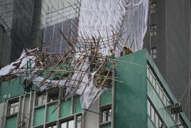 HAVOC: (Above) Bamboo scaffolding in Hong Kong damaged by Typhoon Nida. 