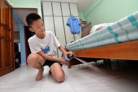BETTER TOTNP PHOTOS: JEREMY LONG BE SAFE: Zhengda spraying insecticide in dark corners of his flat.