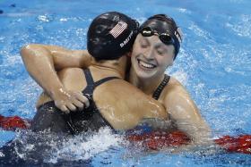 Katie Ledecky (right) celebrates with teammate Leah Smith after winning the women&#039;s 400m freestyle.