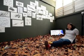 TALENTED: Ms Nur Aqilah Hassan with her work for an exhibition - While They Trim Trees, We Reshuffle Leaves - this year.