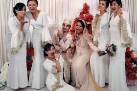 JOYFUL: The couple pose for a picture with the bridesmaids, including local celebrities Cheryl Wee (second from left), Lydia Izzati (third from left) and Munah Bagharib (far right). 