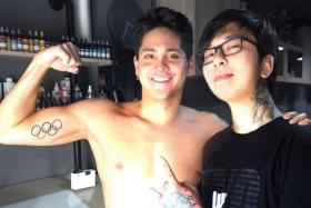 Joseph Schooling (left) and tattoo artist Kelvin Leow. 