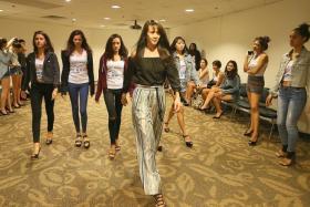 LEARNING FROM THE BEST: Pat Kraal showing the New Face pageant finalists how to take small steps at the end of the runway during her catwalk coaching session.
