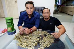 SUPER SAVER: Mr Muhammad Helmy Kamid started saving $1 coins two years ago. He was inspired by his uncle, Mr Anuar Ahmad (above, right).