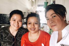 HELPING HAND: Ms Karen Chan (in white) visited Madam Jurina in July to give her the vouchers. Also in the picture is Ms Chan&#039;s friend.