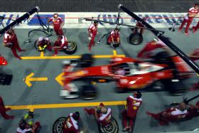 Ferrari Formula One pit crew practise changing tyres in the pit ahead of the Singapore F1 Grand Prix Night Race in Singapore.