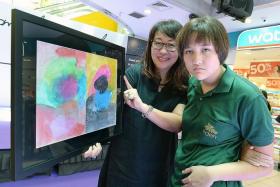 PASSION: Alexandra Ming, 15, and her mother, Mrs Marian Main, 56, with her winning entry Free To Express. 
