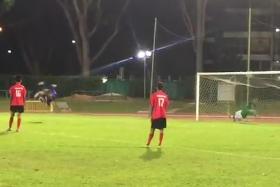 Syafiq Sazali (in blue) of Yishun Sentek Mariners scores a somersault penalty against Kaki Bukit Sports Club.
