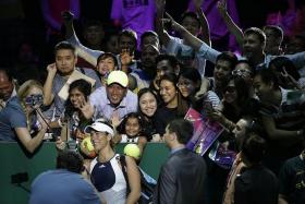 WEFIE: Garbine Muguruza (wearing visor) takes a picture with fans at last year&#039;s WTA Finals at the Indoor Stadium.