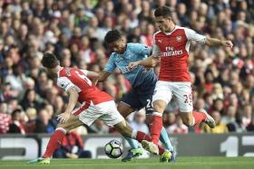 MADE OF STERNER STUFF: The tenacious Granit Xhaka (right) and the much-improved Laurent Koscielny (right) make the Gunners a tough team to beat.