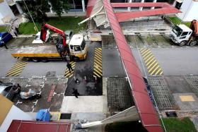 DAMAGED: The crank of a lorry crane hit a covered walkway at Bukit Batok, causing it to collapse.