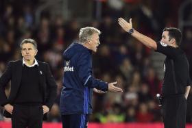 OFF YOU GO: Sunderland manager David Moyes (above, left) is dismissed by referee Chris Kavanagh (right) for swearing at the match officials yesterday morning. Could he be dismissed by the Black Cats soon?