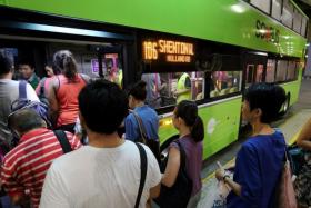 Passengers boarding the Tower Transit bus service 106 at Bukit Batok Bus Interchange.