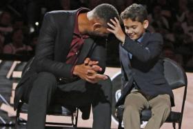 An emotional Tim Duncan is comforted by his son.