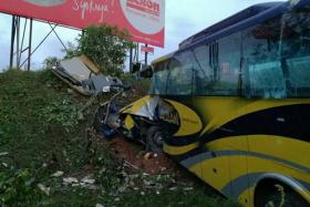 A Kuala Lumpur-bound express coach from Johor Baru crashed into a ravine on the North-South Expressway near Muar, Johor, in the early hours of Saturday, killing 14 people, including three Singaporeans and a Singapore permanent resident.