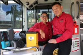 Brothers Foo Kim Siong (in glasses) and Foo Kim Ming used to drive the same bus service. 
