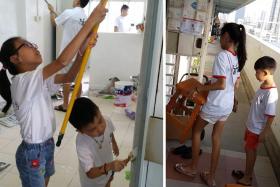  Mr Lim&#039;s daughter, Reane, 12 and son, Reven, 8, helping to paint a wall in one of the flats visited on their weekly Sunday visits to needy homes in Singapore