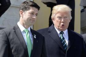  US President Donald J. Trump (R) and House Speaker Paul Ryan (L), walk down the steps of the US Capitol after attending the Friends of Ireland Luncheon