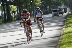 Cyclists cycling along Changi Coastal Road. 