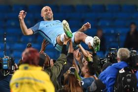 Manchester City&#039;s Argentinian defender Pablo Zabaleta is thrown in the air by his teammates as they and the crowd pay him tribute for his final home appearance for the club 