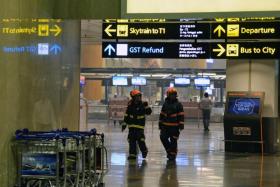 Firemen inspect Changi International Airport terminal 2 in Singapore on May 16, 2017.