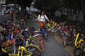 China to impose bike-sharing rules as complaints soar