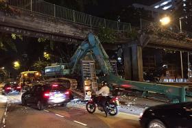 Excavator hits overhead bridge
