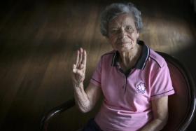 Ms Christabelle Alvis, who has served Girl Guides Singapore for 65 years, giving a Girl Guides salute. 