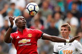 Manchester United&#039;s Paul Pogba in action with Swansea City&#039;s Tom Carroll