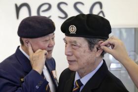 Colonel (Retired) Lau Kee Siong (left) and Lieutenant-Colonel (Retired) Bob Cheah with their barely visible hearing aids at nessa Asia on 14 August 2017. nessa Asia, a company that provides hearing aids, is crowdfunding $20k and matching it dollar for dollar to get hearing aids for members of the SAF Veterans League.