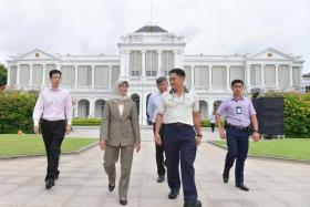 Madam Halimah Yacob touring the grounds in the Istana with (from far left) Principal Private Secretary to the President Benny Lee; head of Istana Programmes and Household Sunny Seah; and NParks group director (Fort Canning and Istana) Wong Tuan Wah.