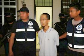Malaysian police arresting a 21-year-old who admitted to receiving guidance from top ISIS fighters to make bombs in Bagan Serai, Perak.