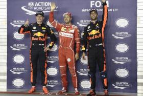 Ferrari&#039;s Sebastian Vettel (centre) secures pole position beside Red Bull&#039;s Max Verstappen (left) and Daniel Ricciardo after the qualifying session of the Formula One Singapore Grand Prix.
