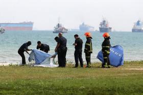 Police officers retrieving the body of Muhammad Suhaimi Sabastian, 12, who was found in the waters off Bedok Jetty on 8 May 2017 after a search operation that lasted three hours. He was reported missing in the waters off East Coast Park after an outing that went awry.