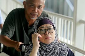 Zariah Mohd Ali (on wheelchair) and her husband Mohamad Dahlan. 