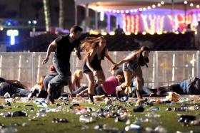People run from the Route 91 Harvest country music festival after a gunman opened fire  on October 1, 2017 in Las Vegas, Nevada.
