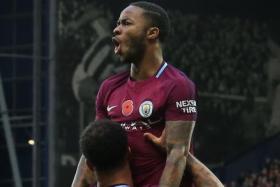 Manchester City’s Kyle Walker giving Raheem Sterling a lift after the latter scored City’s third goal with his frst touch after coming off the bench.