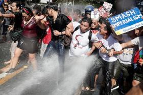 Protesters hosed down by riot police