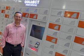 NLB chief information officer Lee Kee Siang with one of the reservation lockers at a library.