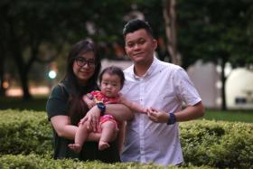 Mrs Pearlin Lee, 38, and Mr Gary Lee, 30, who are both deaf, together with their six-month old daughter, Mirae.