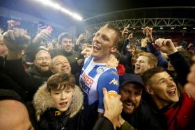 Wigan Athletic&#039;s Dan Burn celebrating with their fans after their FA Cup win over Man City.