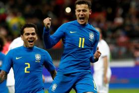 Brazil&#039;s Philippe Coutinho (right) celebrating with Dani Alves after scoring.