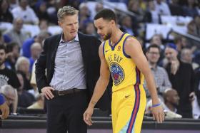Golden State Warriors star Stephen Curry (right) will be re-evaluated in three weeks,  right around when the NBA play-offs are scheduled to begin on April 14.