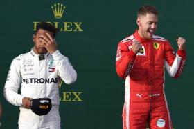 Ferrari&#039;s Sebastian Vettel (right) celebrates on the podium as Lewis Hamilton ponders a return to the drawing board for Mercedes.