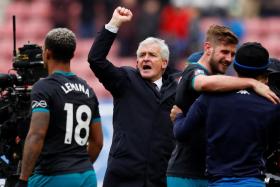 Southampton manager Mark Hughes (centre) celebrates after the Saints defeated Wigan in the FA Cup quarter-finals earlier this month.