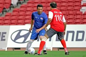 Singapore legend Fandi Ahmad (left) in action during an exhibition game.