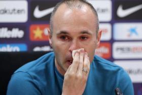 Andres Iniesta turning emotional during a press conference where he announced his decision to leave Barcelona.